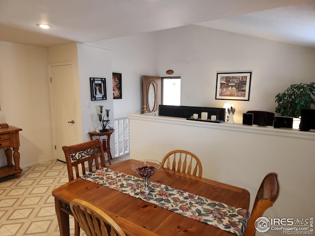 dining space with lofted ceiling