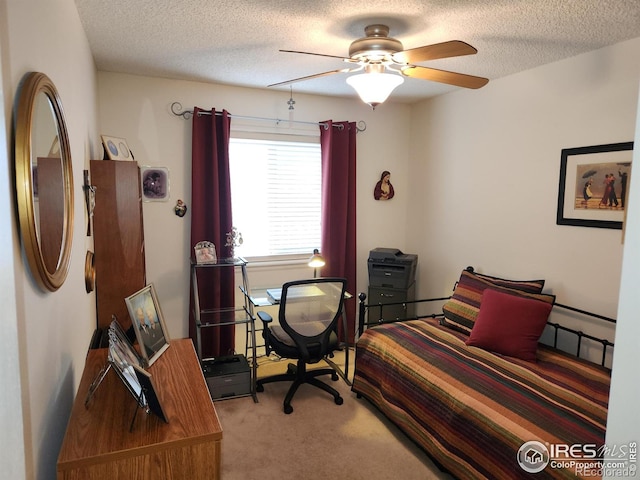 bedroom featuring ceiling fan, carpet flooring, and a textured ceiling