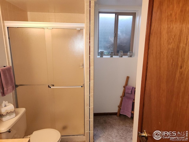 bathroom featuring toilet and walk in shower