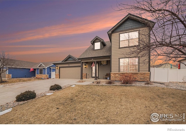 view of front of home featuring a yard and a garage