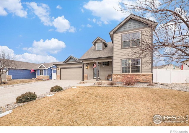 view of front of property with a garage, a front lawn, and a porch