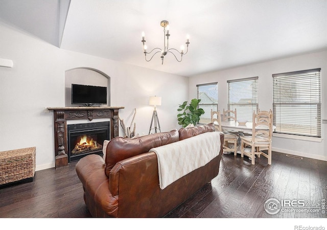 living room featuring dark hardwood / wood-style floors and a chandelier