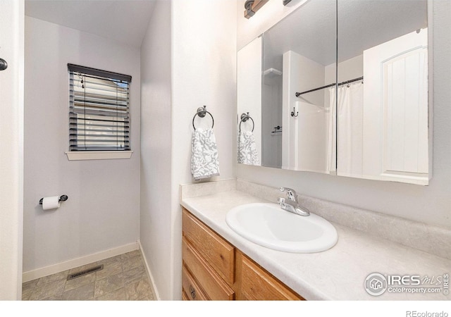 bathroom featuring vanity and a shower with shower curtain