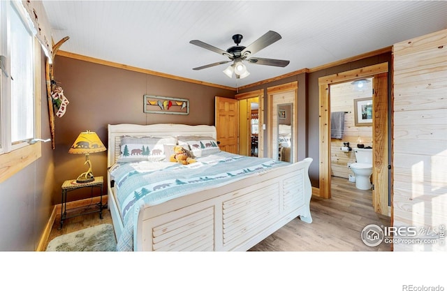 2420 Big Owl Rd, Allenspark, CO 80510 - bedroom with crown molding, ceiling fan, wooden walls, ensuite bathroom, and light wood-type flooring
