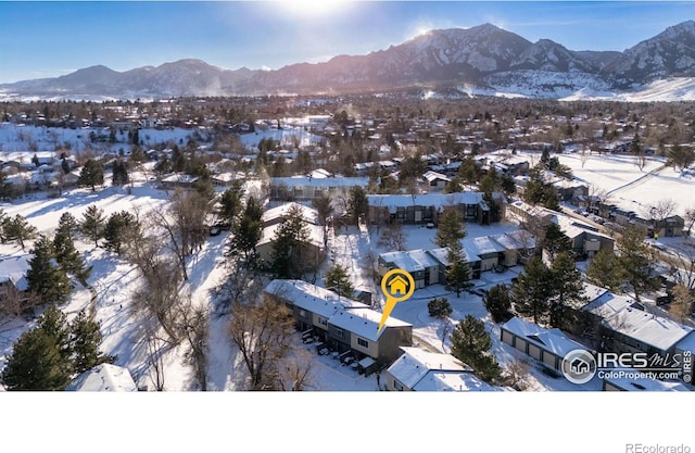 snowy aerial view with a mountain view