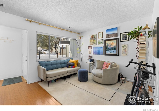 living room featuring hardwood / wood-style flooring and a textured ceiling