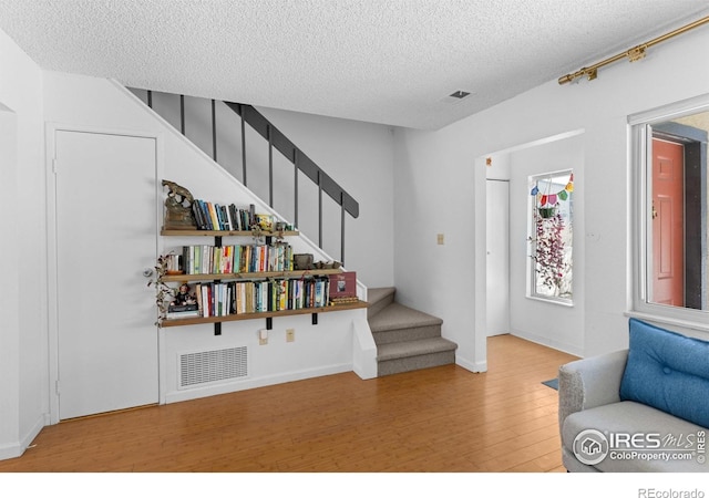 foyer with hardwood / wood-style flooring and a textured ceiling