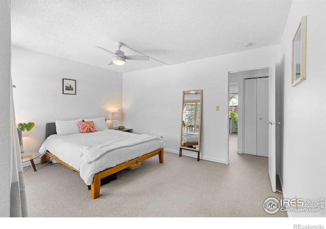 bedroom with ceiling fan and a textured ceiling