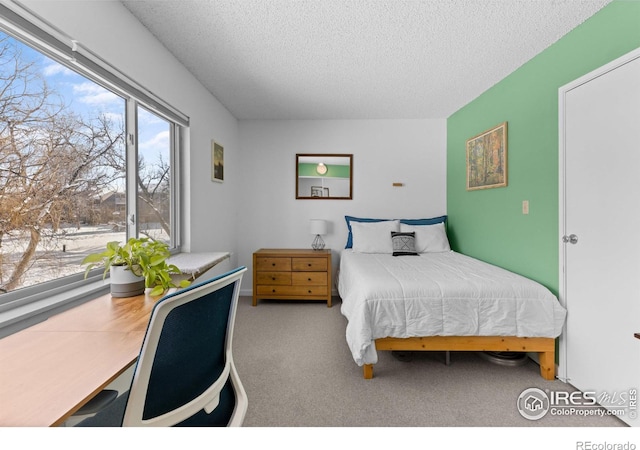 carpeted bedroom featuring a textured ceiling