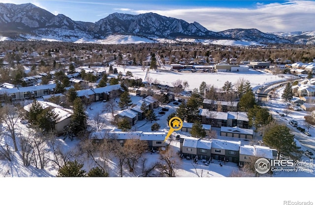 snowy aerial view with a mountain view