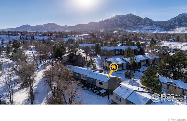 snowy aerial view with a mountain view