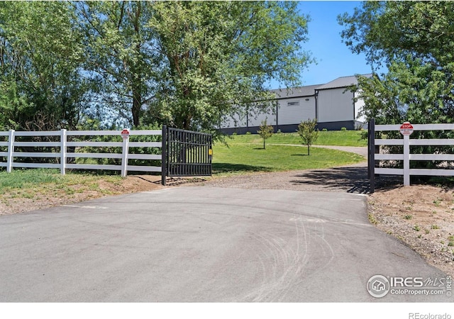 view of gate featuring a yard