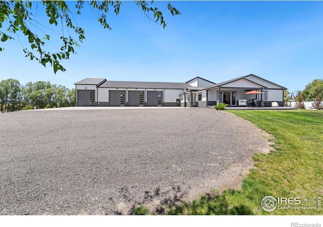 view of front of property with a garage and a front lawn