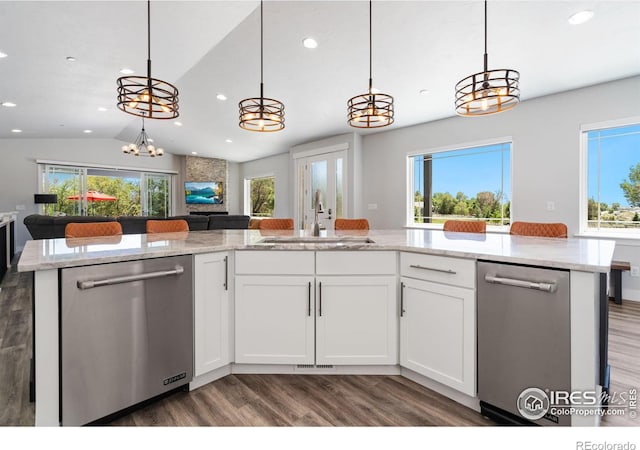 kitchen with stainless steel dishwasher, sink, and white cabinets