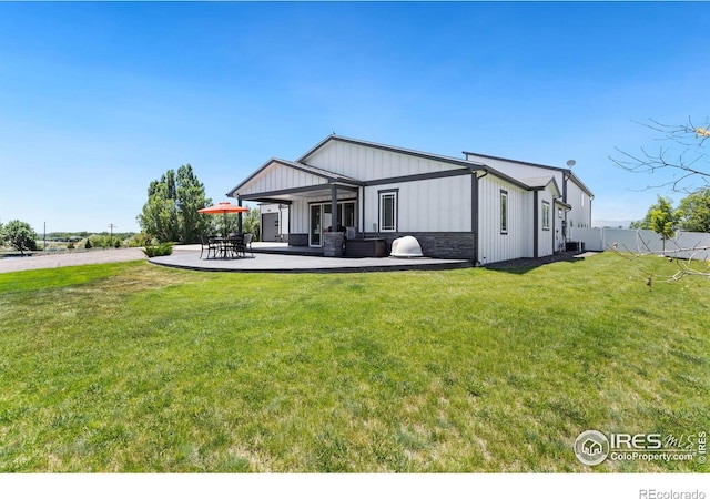 view of front of house featuring a front lawn and a patio