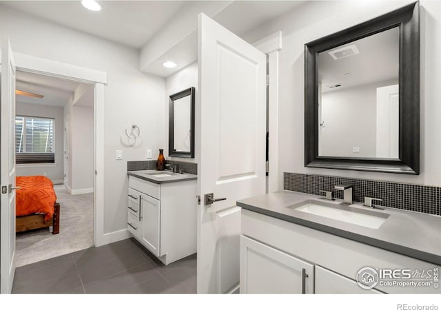 bathroom with tasteful backsplash, vanity, and tile patterned floors