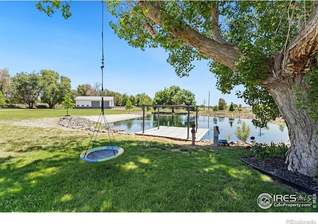 dock area with a water view and a lawn