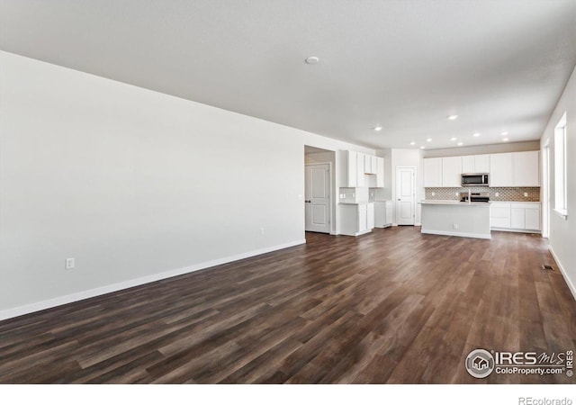 unfurnished living room with dark hardwood / wood-style floors