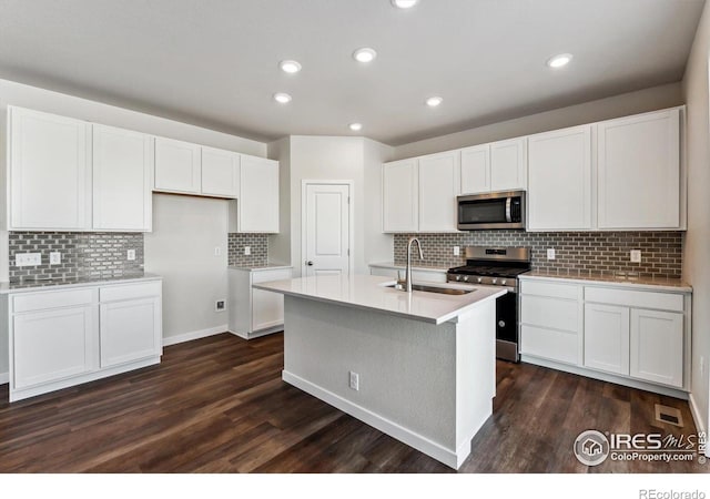 kitchen with stainless steel appliances, sink, and white cabinets