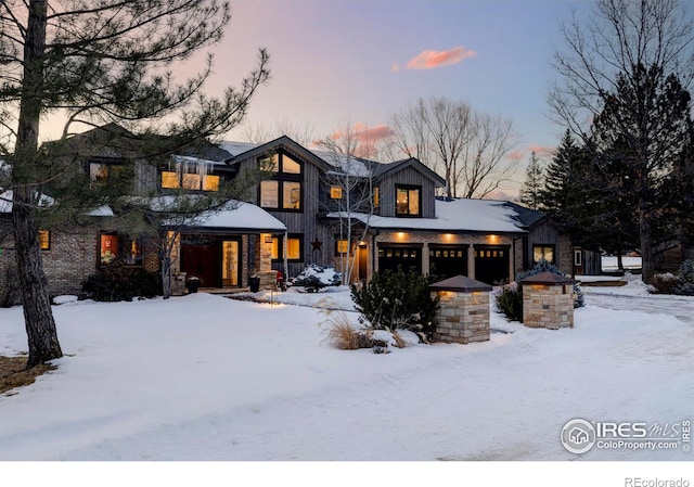 view of snow covered rear of property