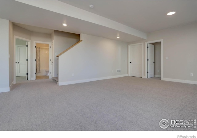 basement featuring light colored carpet