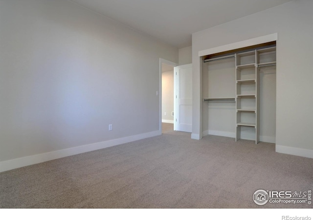 unfurnished bedroom with carpet floors and a closet