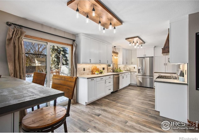 kitchen with white cabinetry, sink, decorative backsplash, and appliances with stainless steel finishes