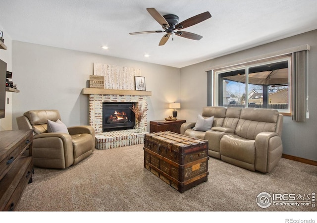 living room featuring light carpet, a fireplace, and ceiling fan