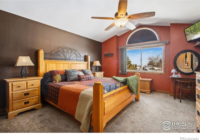 bedroom with ceiling fan, lofted ceiling, and carpet