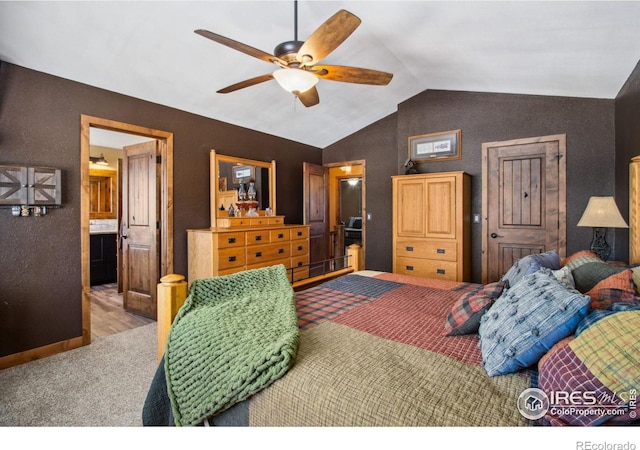 carpeted bedroom with connected bathroom, vaulted ceiling, and ceiling fan