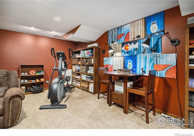 home office with lofted ceiling and carpet flooring