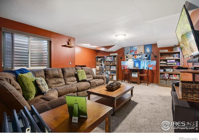 carpeted living room featuring vaulted ceiling