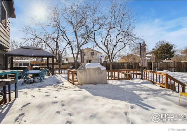 snowy yard with a gazebo