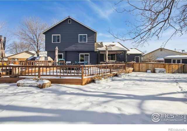 snow covered property featuring a wooden deck