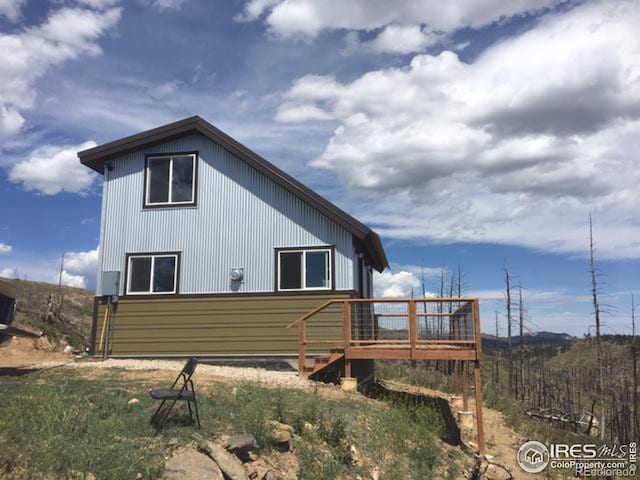 view of side of property with a wooden deck