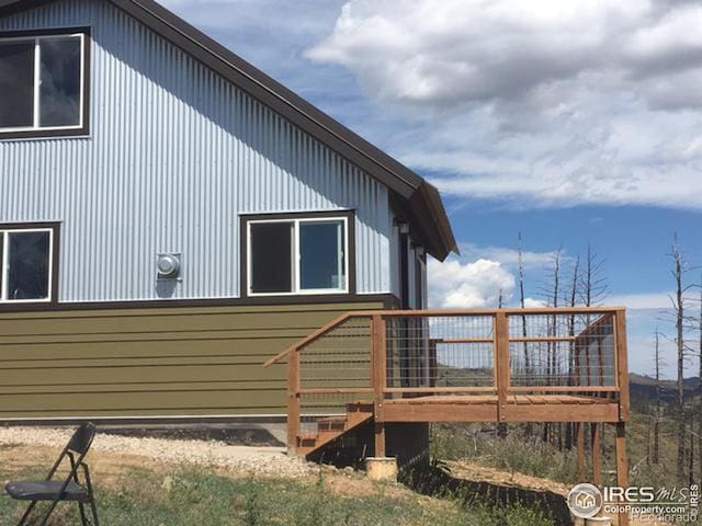 view of side of home featuring a wooden deck