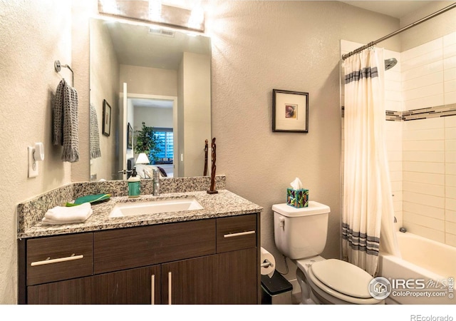 full bathroom featuring vanity, shower / tub combo with curtain, and toilet