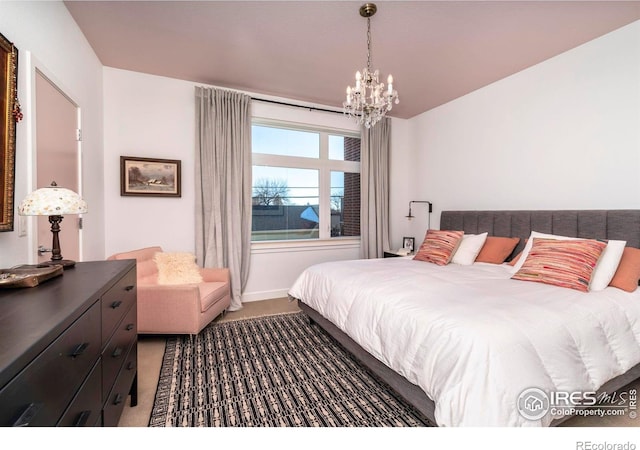 carpeted bedroom with an inviting chandelier