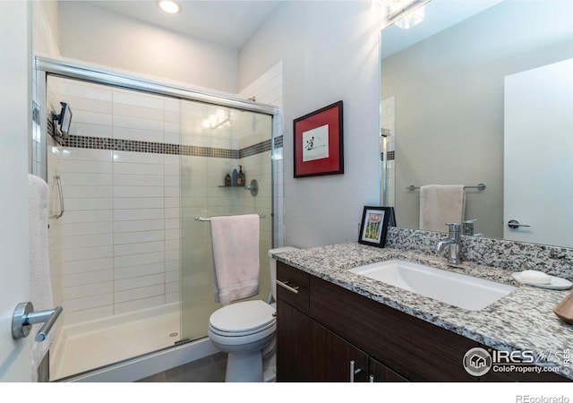 bathroom with vanity, an enclosed shower, tile patterned floors, and toilet