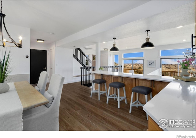 kitchen with an inviting chandelier, decorative light fixtures, and dark hardwood / wood-style floors