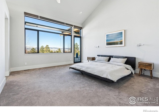 bedroom featuring carpet, access to outside, and high vaulted ceiling