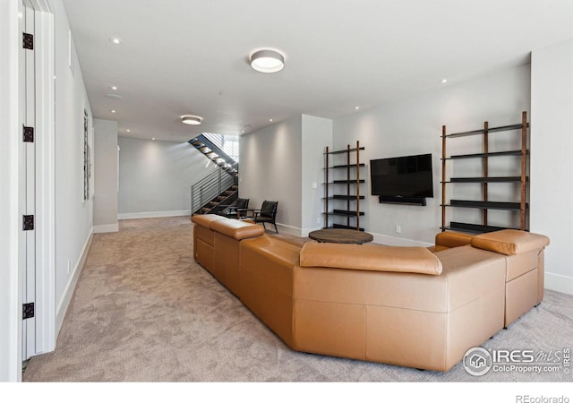 carpeted living room featuring stairs, baseboards, and recessed lighting