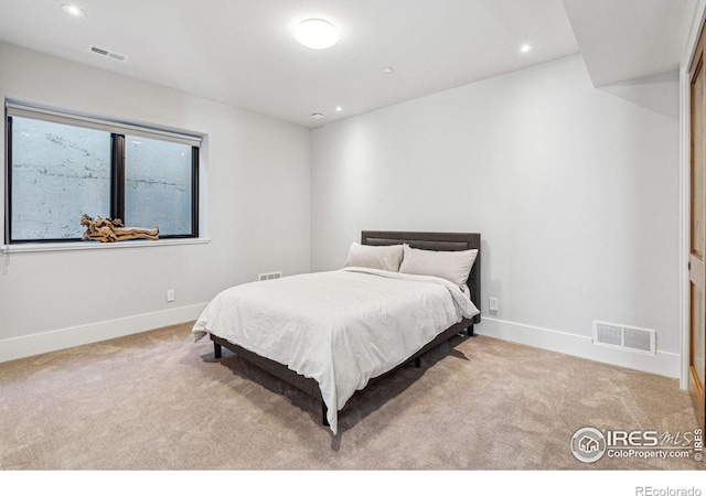 bedroom featuring carpet flooring, visible vents, and baseboards