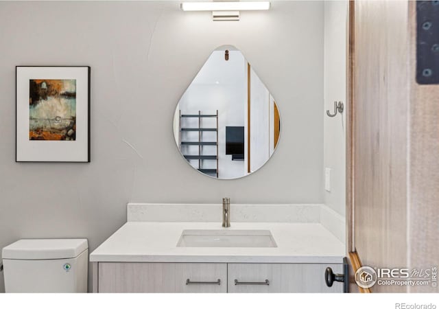 bathroom featuring toilet and vanity