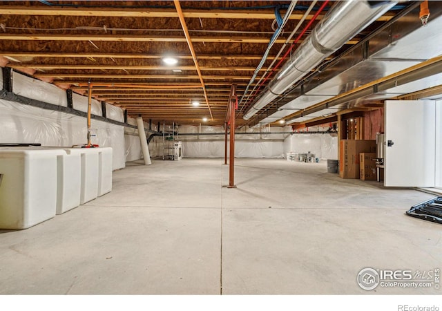 unfinished basement with washer / clothes dryer