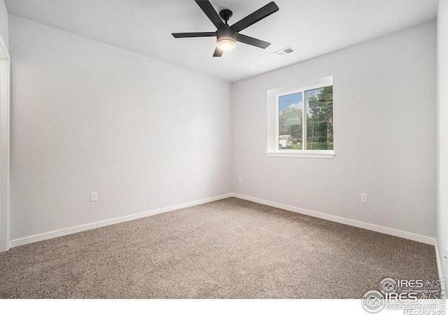 spare room with ceiling fan and carpet