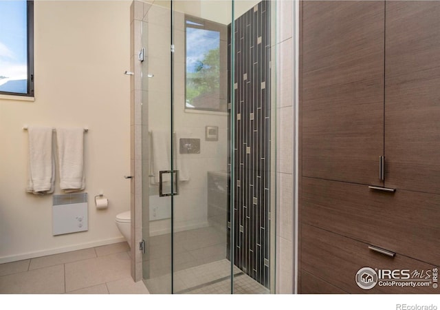 bathroom with an enclosed shower, tile patterned floors, and toilet