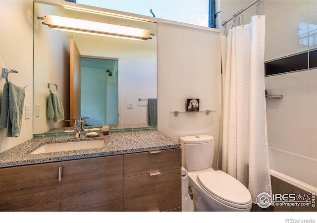 full bathroom featuring vanity, shower / bath combination with curtain, and toilet