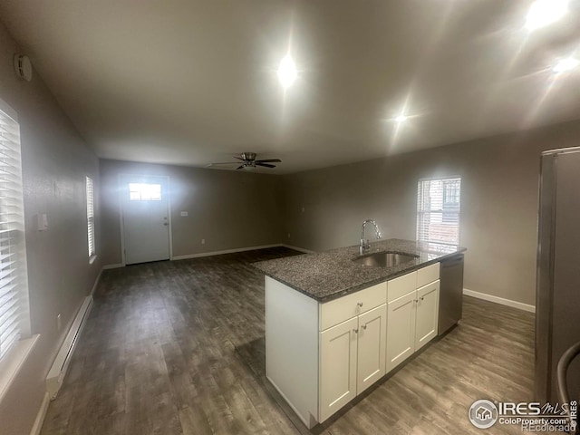 kitchen with sink, dishwasher, white cabinetry, a kitchen island with sink, and a baseboard heating unit