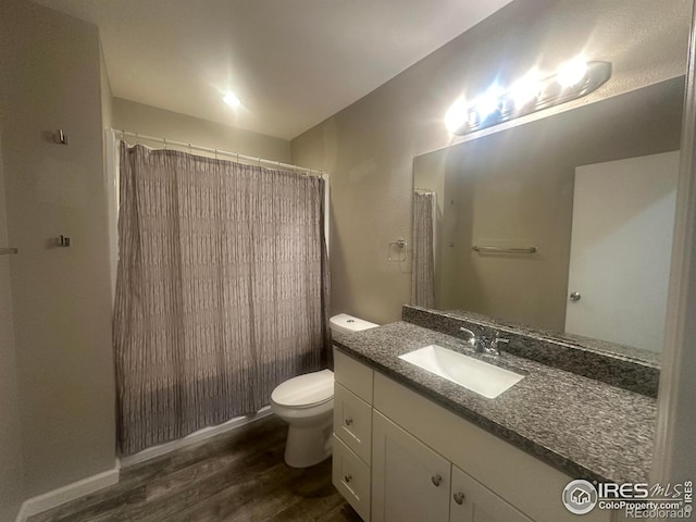 bathroom featuring vanity, hardwood / wood-style flooring, toilet, and a shower with shower curtain